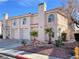 Charming townhome featuring desert landscaping, attached garage, and red tile roofing at 8067 Dorinda Ave, Las Vegas, NV 89147