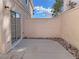 Enclosed patio with desert landscaping and neutral-toned privacy wall at 8067 Dorinda Ave, Las Vegas, NV 89147