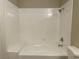 Shower-tub featuring white tile walls, a shower head, and a soap dish at 8067 Dorinda Ave, Las Vegas, NV 89147