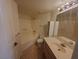 Traditional bathroom with a tub, toilet, and sink with ample counter space at 8455 W Sahara Ave # 226, Las Vegas, NV 89117