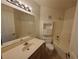 Bathroom with a white vanity, toilet, and shower-tub combo with built-in storage at 8455 W Sahara Ave # 226, Las Vegas, NV 89117