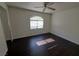 Bright bedroom with dark wood floors, a ceiling fan, and a large mirror at 8455 W Sahara Ave # 226, Las Vegas, NV 89117