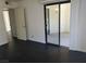Bedroom with a sliding glass door to the patio, white walls, and dark floors at 8455 W Sahara Ave # 226, Las Vegas, NV 89117