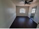 Cozy bedroom with dark wood floors, a ceiling fan, and a large mirror at 8455 W Sahara Ave # 226, Las Vegas, NV 89117