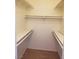 Walk-in closet with carpet and built-in shelves and rods for ample storage at 8455 W Sahara Ave # 226, Las Vegas, NV 89117