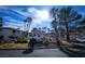 Community clubhouse with lush landscaping, palm trees and green grass at 8455 W Sahara Ave # 226, Las Vegas, NV 89117