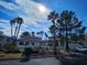Community clubhouse featuring palm trees and lush landscaping at 8455 W Sahara Ave # 226, Las Vegas, NV 89117