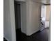Hallway leading to bedrooms and entryway with dark flooring and white trim at 8455 W Sahara Ave # 226, Las Vegas, NV 89117