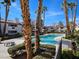 Beautiful community pool with palm trees and lounge seating at 8455 W Sahara Ave # 226, Las Vegas, NV 89117