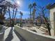 Community pool featuring mature landscaping and benches at 8455 W Sahara Ave # 226, Las Vegas, NV 89117