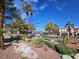 Scenic street view of community with mature landscaping and trees at 8455 W Sahara Ave # 226, Las Vegas, NV 89117