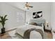 Bedroom with a ceiling fan and modern decor features bright natural light from a window at 9050 W Warm Springs Rd # 2153, Las Vegas, NV 89148