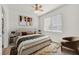 Staged bedroom with ceiling fan, neutral walls, and bright natural light from large window at 9050 W Warm Springs Rd # 2153, Las Vegas, NV 89148