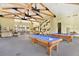 Spacious recreation center with billiards tables, elegant furnishings, and high ceilings with exposed beams at 9050 W Warm Springs Rd # 2153, Las Vegas, NV 89148
