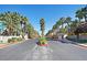 Community entrance lined with mature palm trees and manicured landscaping at 9050 W Warm Springs Rd # 2153, Las Vegas, NV 89148