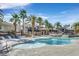 Resort-style pool with palm trees and comfortable lounge seating for relaxation at 9050 W Warm Springs Rd # 2153, Las Vegas, NV 89148