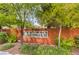 Cottonwood Terrace entrance featuring mature landscaping and a decorative community sign on an attractive brick wall at 908 Majestic Oak St, Las Vegas, NV 89145