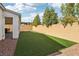Spacious backyard with artificial turf and brick perimeter wall and covered patio at 9690 Hiking Ave, Las Vegas, NV 89166