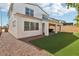 Charming backyard with artificial grass, a covered patio, a rock border, and a stucco exterior at 9690 Hiking Ave, Las Vegas, NV 89166