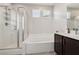 Well-lit bathroom featuring a shower, bathtub, vanity, and sleek fixtures at 9690 Hiking Ave, Las Vegas, NV 89166
