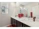Bright bathroom offers double sinks, a large mirror, and modern fixtures at 9690 Hiking Ave, Las Vegas, NV 89166