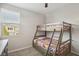 Bedroom features a bunk bed and window to allow ample lighting at 9690 Hiking Ave, Las Vegas, NV 89166