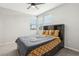 This bedroom features a ceiling fan, a bed, and large windows that provide lots of light at 9690 Hiking Ave, Las Vegas, NV 89166