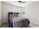 This bedroom features a ceiling fan, a bed, and large windows that provide lots of light at 9690 Hiking Ave, Las Vegas, NV 89166