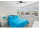 Bright bedroom with a ceiling fan, plush carpeting and several large windows at 9690 Hiking Ave, Las Vegas, NV 89166