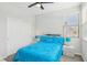 Bedroom boasts a ceiling fan, plush carpeting, and natural light from a large window at 9690 Hiking Ave, Las Vegas, NV 89166