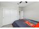 Bedroom boasts a ceiling fan, closet and a comfy bed at 9690 Hiking Ave, Las Vegas, NV 89166