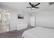 Bright bedroom featuring a flat screen television, sleek white dresser, and an open door to the Primary bathroom at 9690 Hiking Ave, Las Vegas, NV 89166