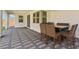 This covered patio features a patterned gray brick floor and a dining table with seating for six at 9690 Hiking Ave, Las Vegas, NV 89166