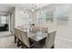 Bright dining room featuring a large table with seating for eight and stylish lighting fixture at 9690 Hiking Ave, Las Vegas, NV 89166