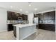Spacious kitchen featuring a center island, stainless steel appliances, and dark wood cabinetry at 9690 Hiking Ave, Las Vegas, NV 89166