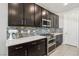 Modern kitchen featuring stainless steel appliances, tile backsplash, and ample counter space at 9690 Hiking Ave, Las Vegas, NV 89166