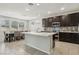 Well-lit kitchen with a large island, stainless steel appliances, and an adjacent dining area at 9690 Hiking Ave, Las Vegas, NV 89166