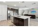 Bright kitchen with stainless steel appliances, granite countertops, and dark wood cabinets at 9690 Hiking Ave, Las Vegas, NV 89166