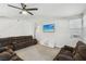 Comfortable living room with large sectional, ceiling fan, and neutral wall color at 9690 Hiking Ave, Las Vegas, NV 89166