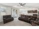 Spacious living room with sliding door access to backyard, open to the dining area at 9690 Hiking Ave, Las Vegas, NV 89166