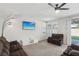 Inviting living room with modern ceiling fan, large window, and sliding door to backyard at 9690 Hiking Ave, Las Vegas, NV 89166