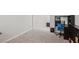 Carpeted flex room with black shelving and desk, great for a home office or study at 9690 Hiking Ave, Las Vegas, NV 89166