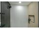 Modern shower features a tile surround, sleek fixtures, and recessed niche at 9741 Panorama Cliff Dr, Las Vegas, NV 89134