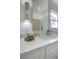 Modern bathroom vanity with white countertop, updated sink, light fixture and mirror at 9741 Panorama Cliff Dr, Las Vegas, NV 89134