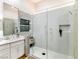This bathroom boasts a glass shower, sleek white tile, and a stylish vanity with a marble countertop at 9741 Panorama Cliff Dr, Las Vegas, NV 89134