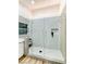 This bathroom boasts a glass shower, sleek white tile, and a stylish vanity with a marble countertop at 9741 Panorama Cliff Dr, Las Vegas, NV 89134