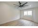 Bedroom features updated flooring, fresh white paint, and a window with a view to the outside at 9741 Panorama Cliff Dr, Las Vegas, NV 89134
