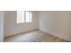Bright bedroom features new laminate flooring, white trim, and a window bringing in natural light at 9741 Panorama Cliff Dr, Las Vegas, NV 89134