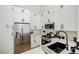 Modern kitchen with stainless steel appliances, including a microwave, refrigerator, and a marble countertop at 9741 Panorama Cliff Dr, Las Vegas, NV 89134