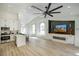 Bright living room boasts a kitchen, modern finishes, and an entertainment center with a fireplace at 9741 Panorama Cliff Dr, Las Vegas, NV 89134